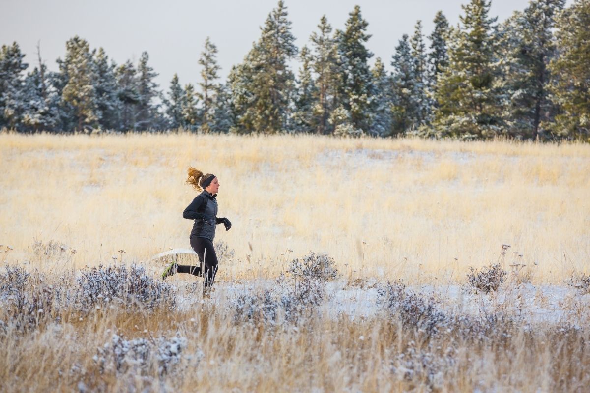 Woman trail running in winter