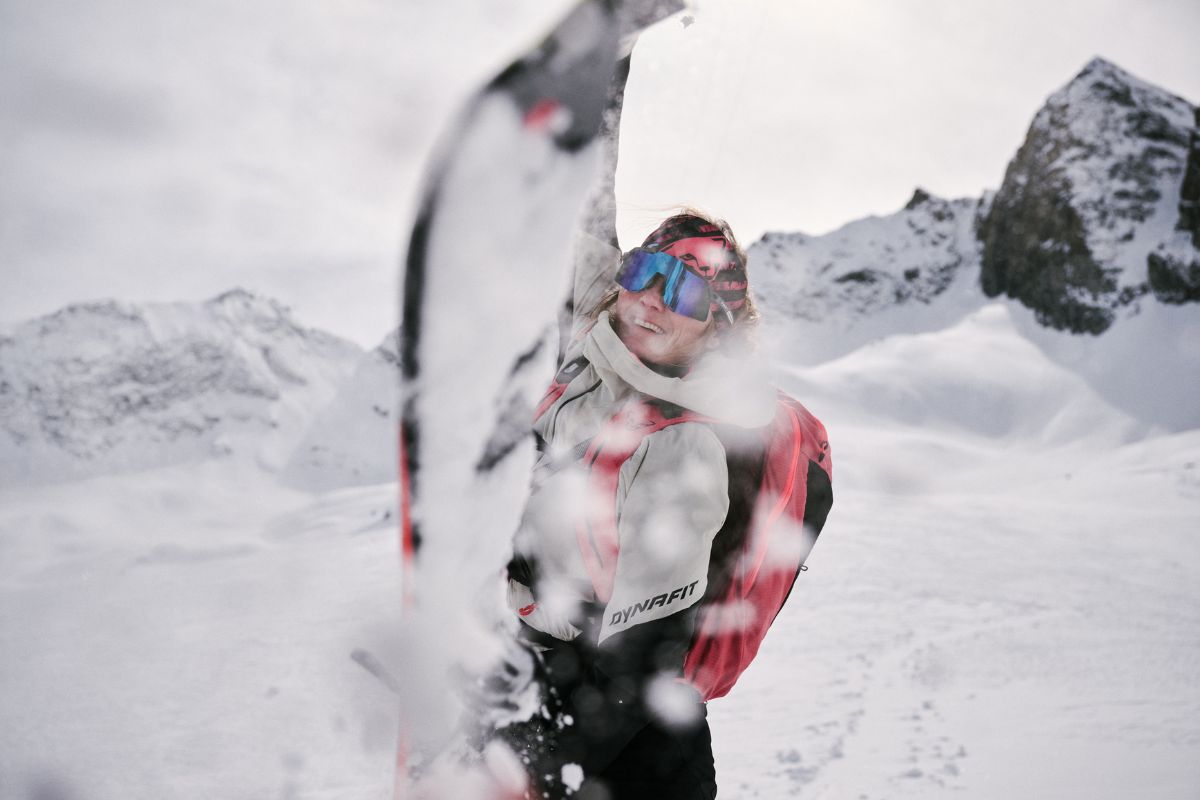 Woman removes fur while ski touring