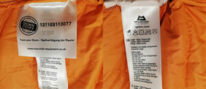 Care label on a down jacket showing washing instructions.